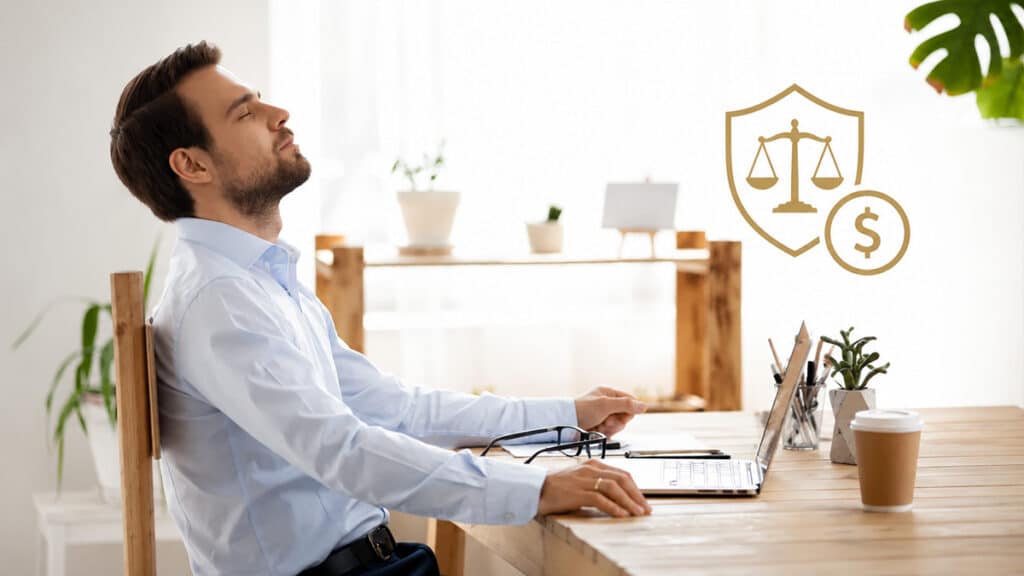 Business owner sitting at a desk reviewing finances related to child support and company income.