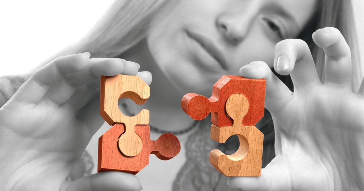 Woman putting puzzle pieces together